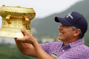 Golf Holiday Vietnam champion golfer lifting golden trophy at Legends Vietnam tournament